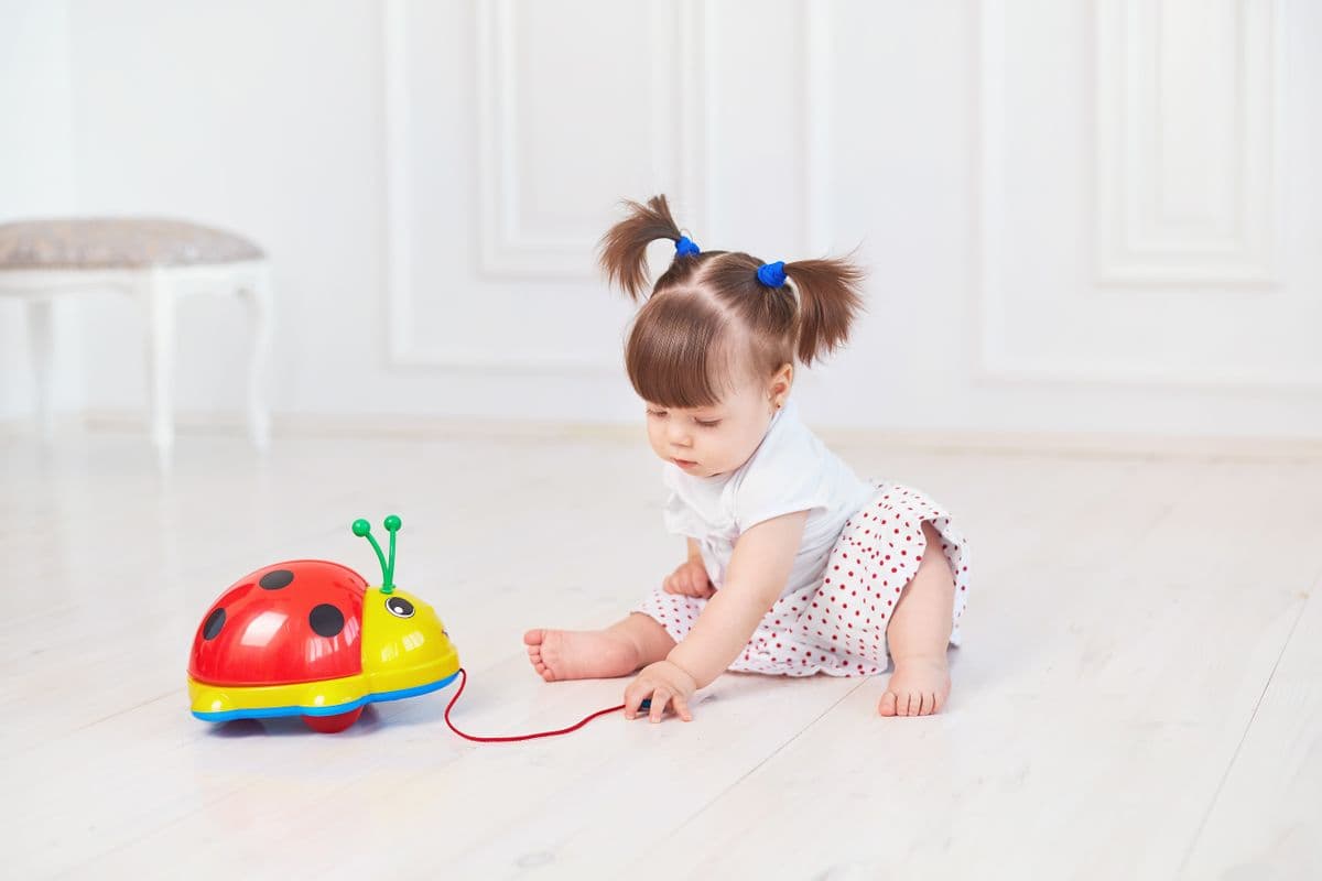 A two-year-old stacking large soft blocks