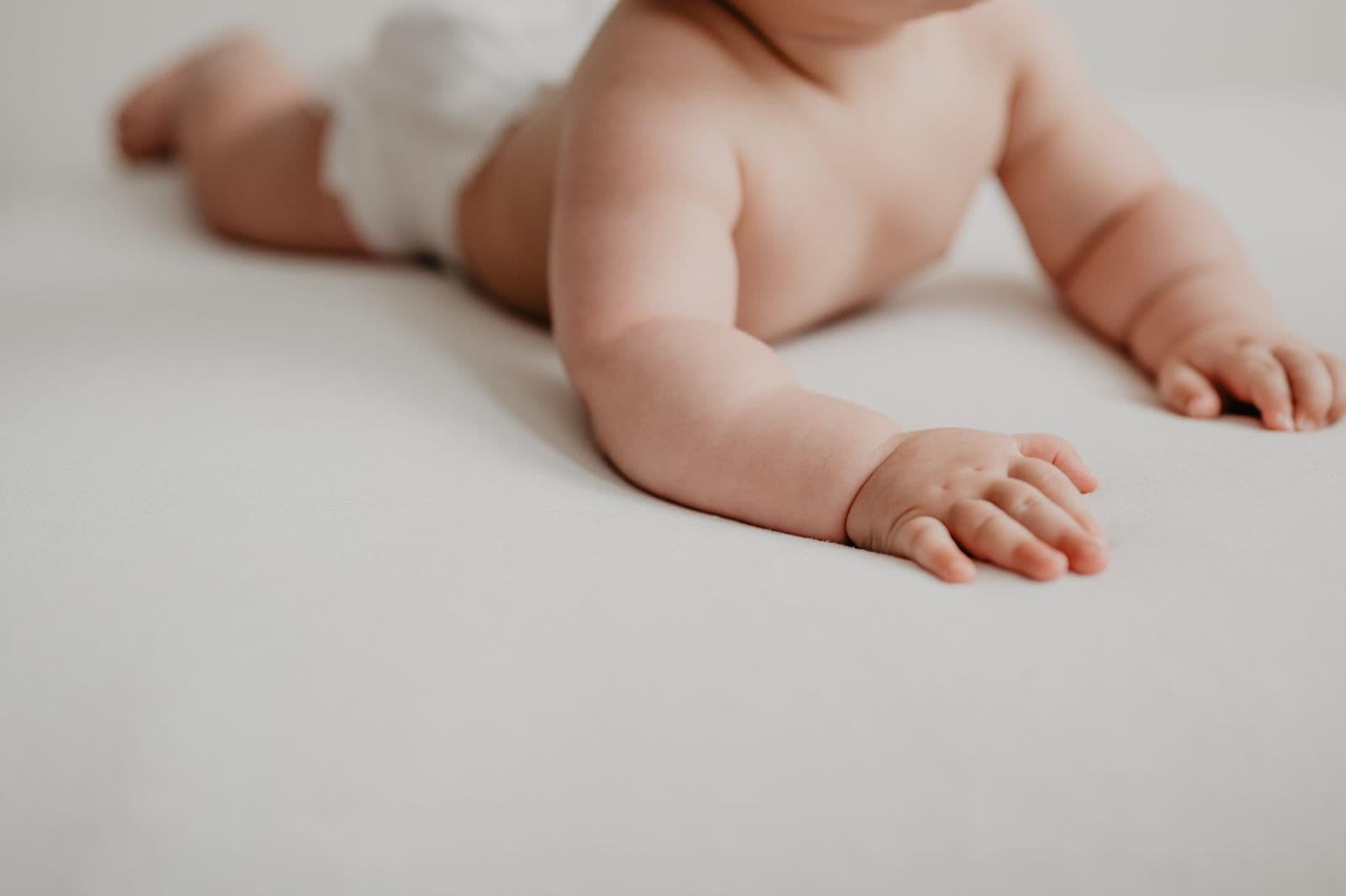 A baby crawling across the floor