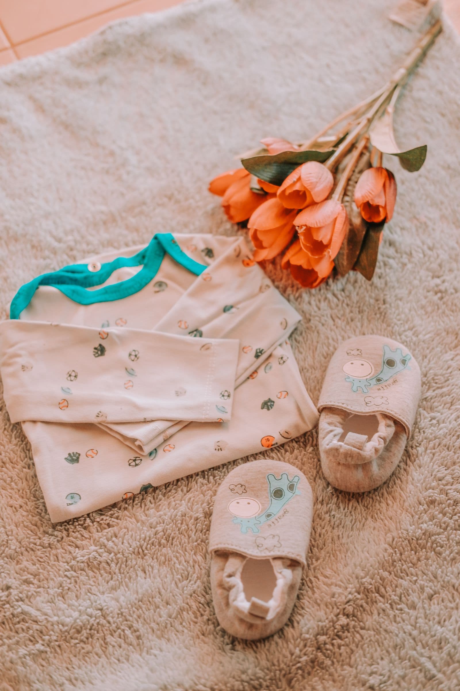 Baby clothes and essentials laid out