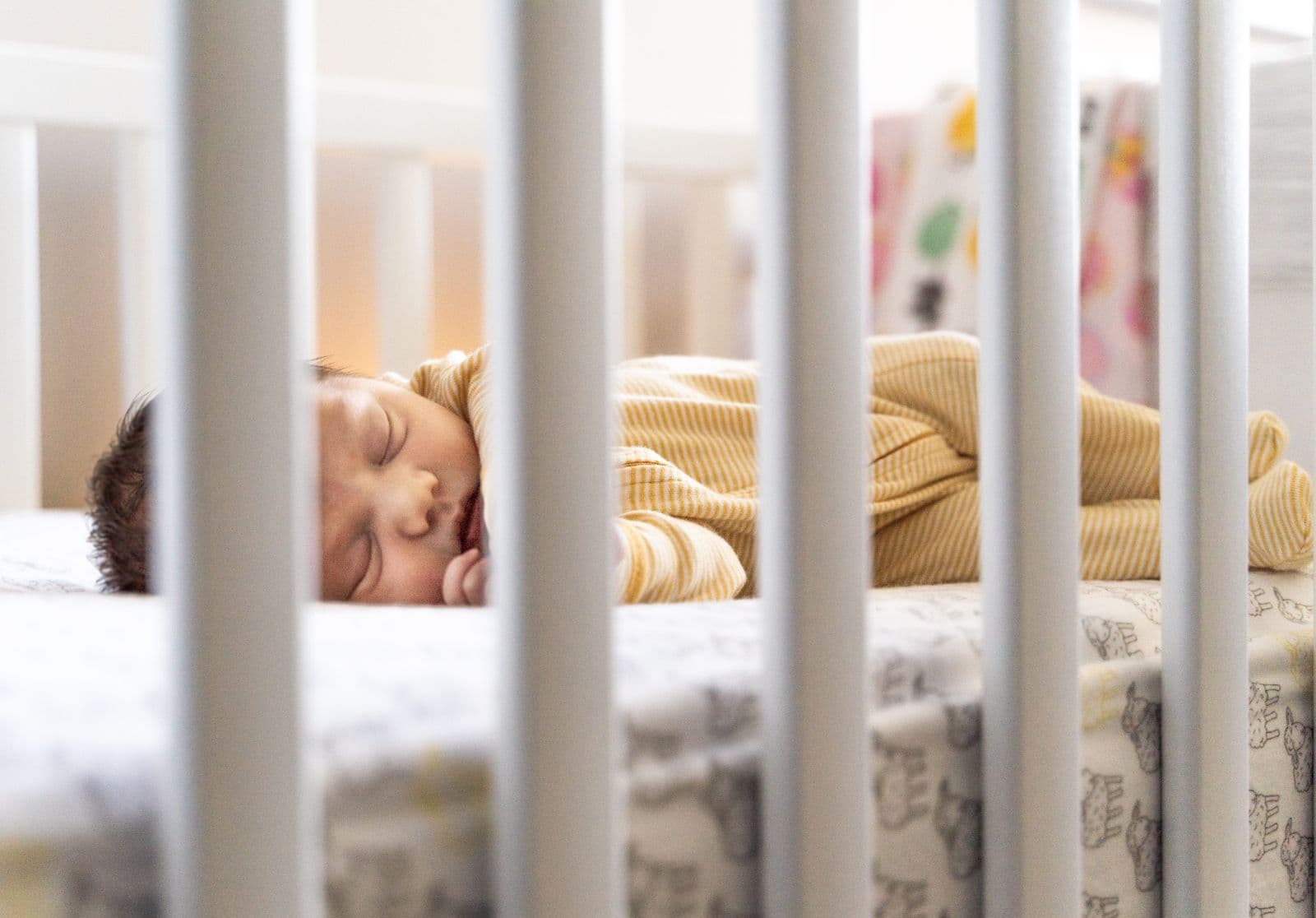 A baby sleeping in a crib