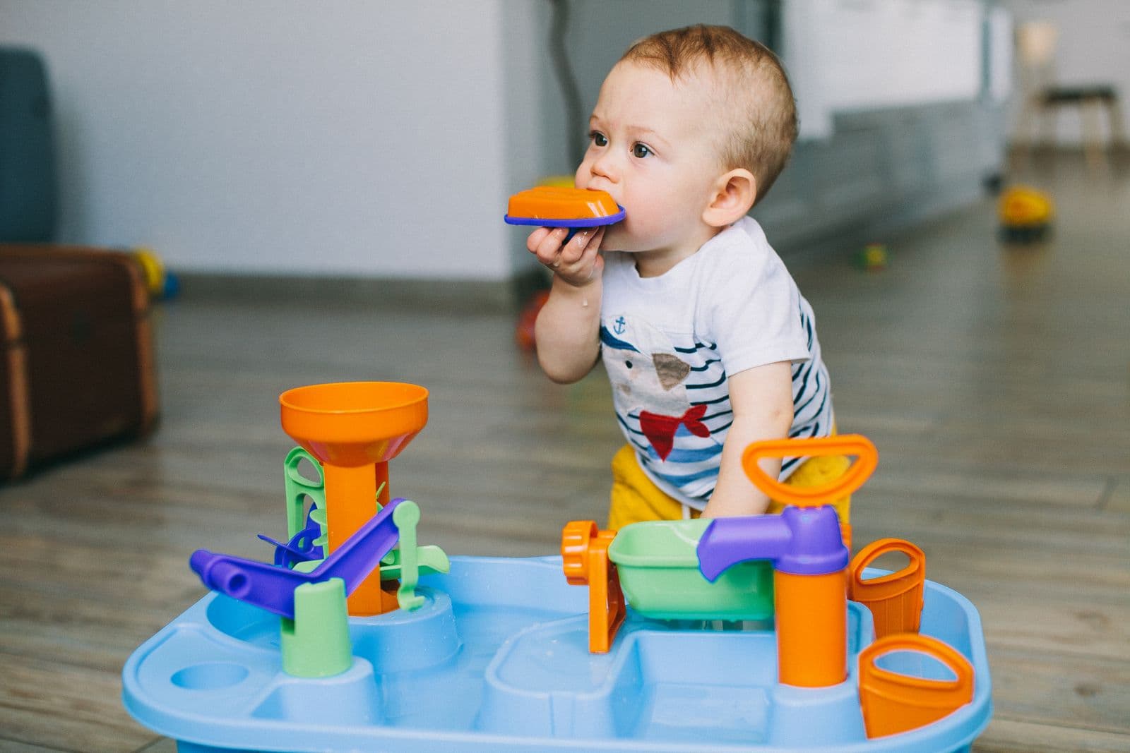 A baby chewing on a teething toy