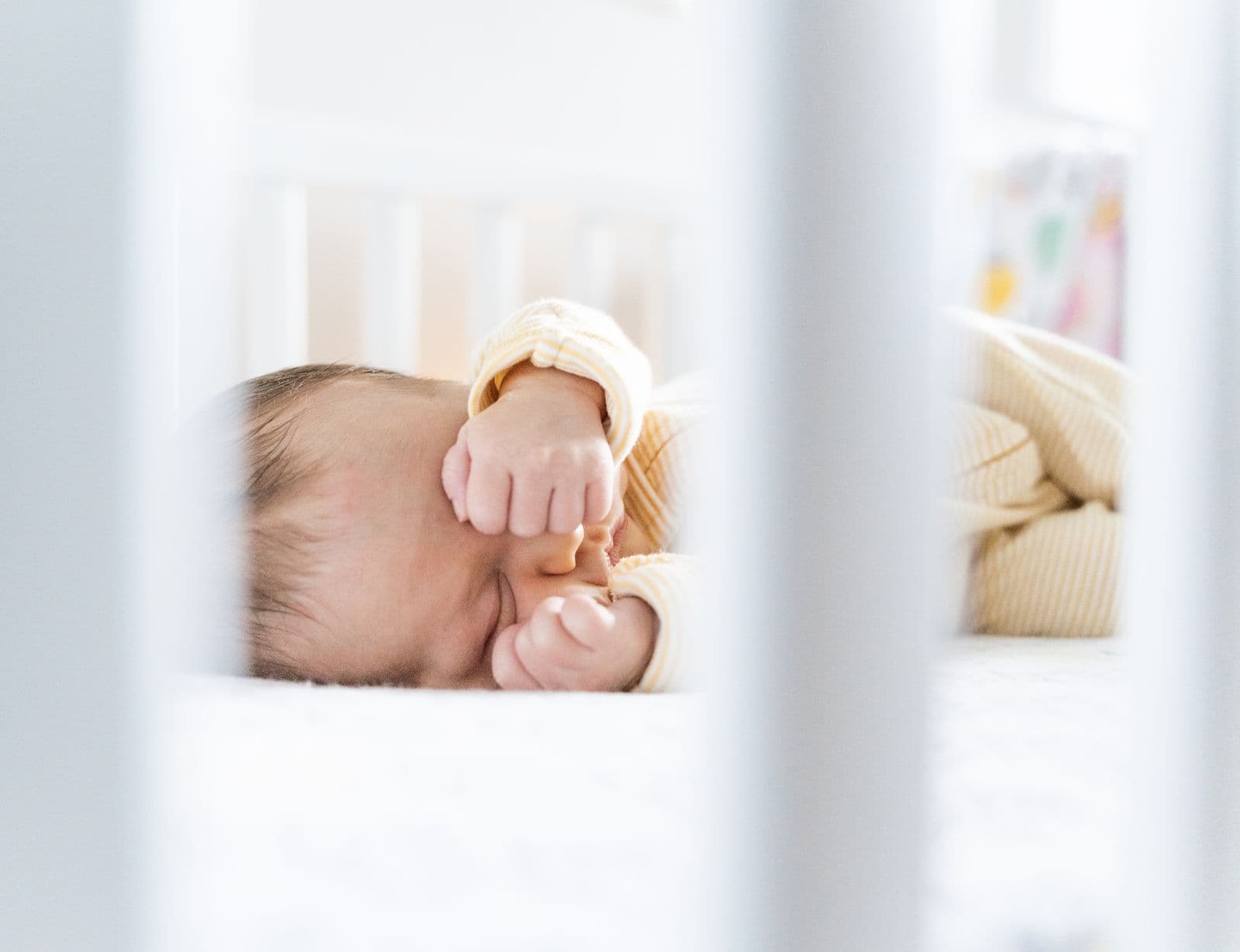 A baby resting in a crib