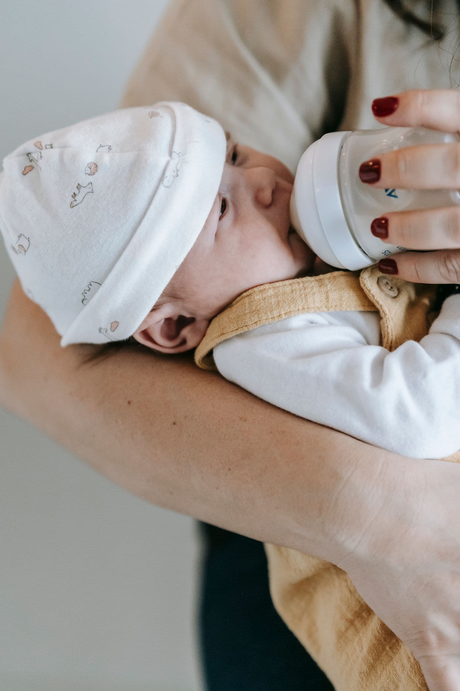 A mother feeding her newborn a bottle