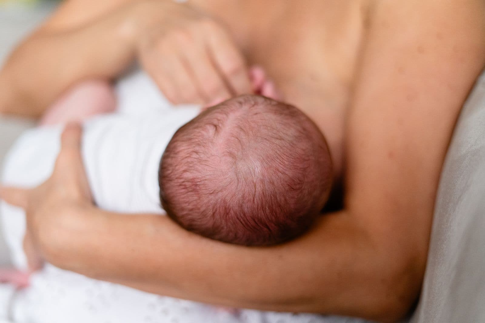 A mother nursing her newborn