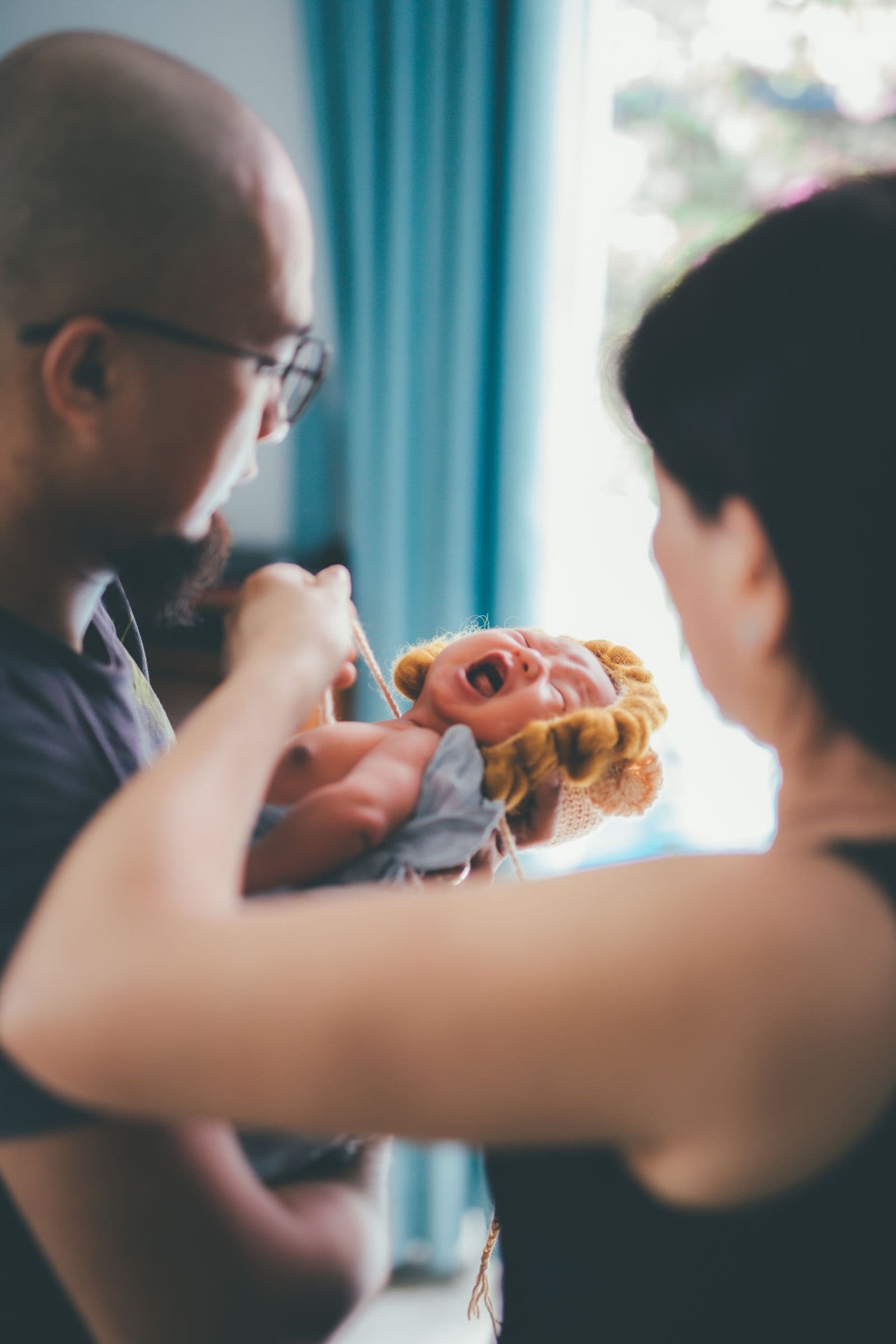 Parents comforting a crying baby at home