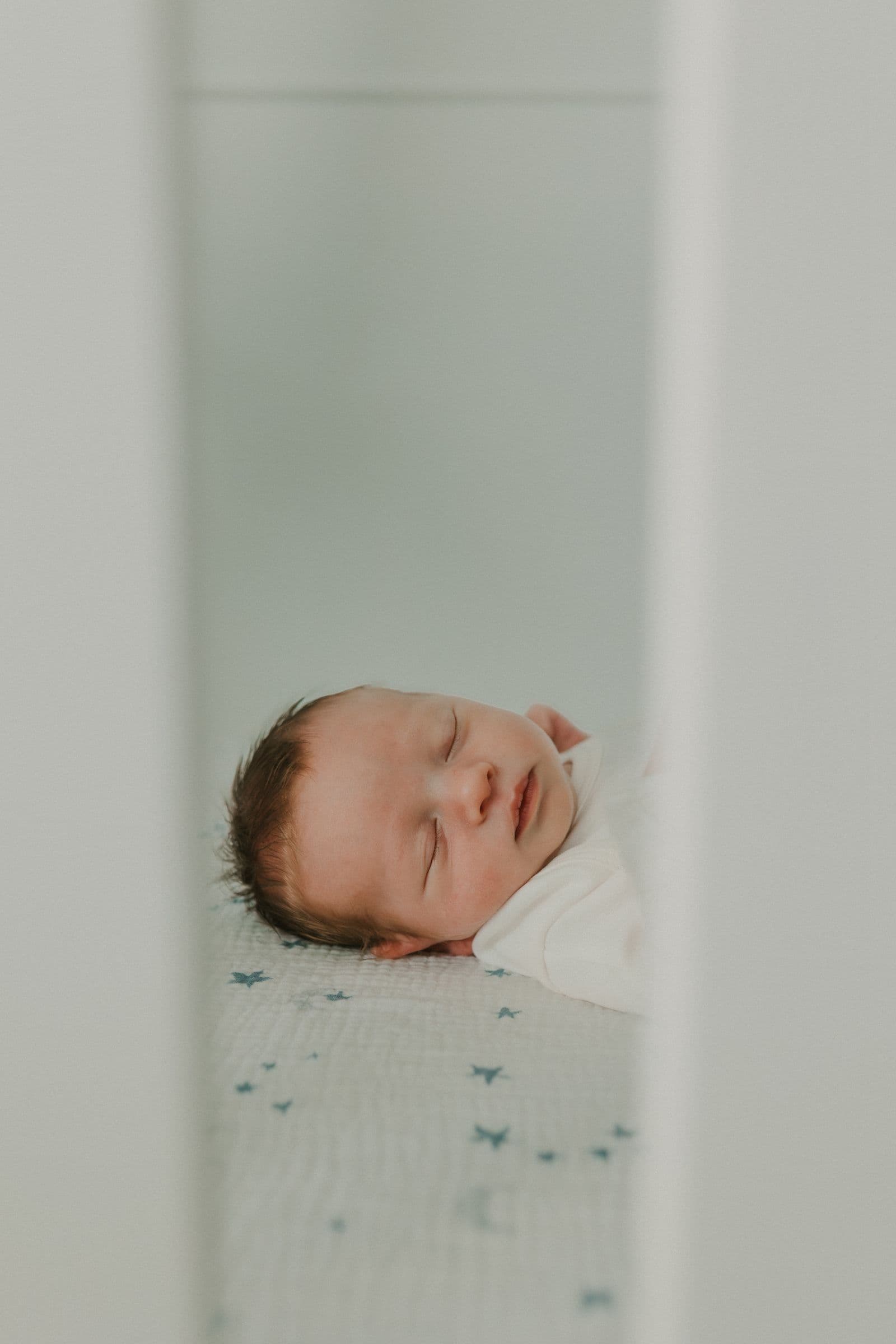 A young child sleeping peacefully in a crib