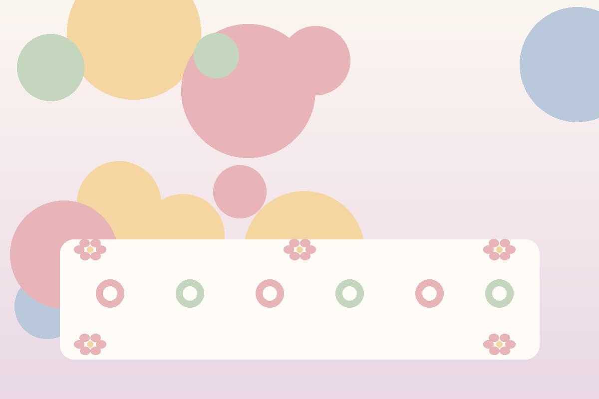 A softly decorated table set for a baby celebration with pastel place settings and simple floral accents