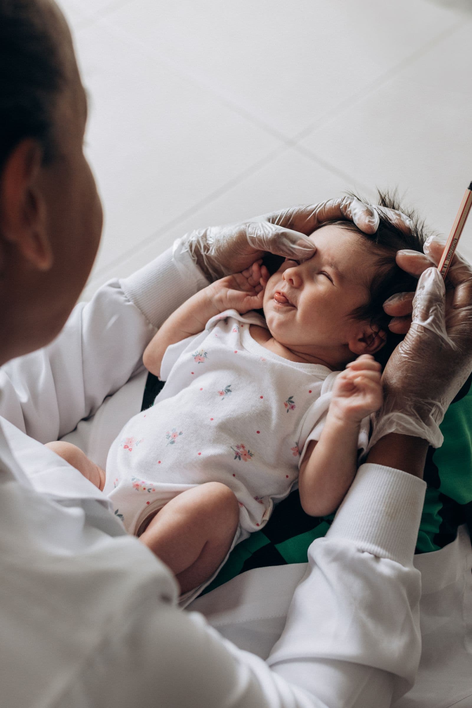 A healthcare professional gently examining a newborn