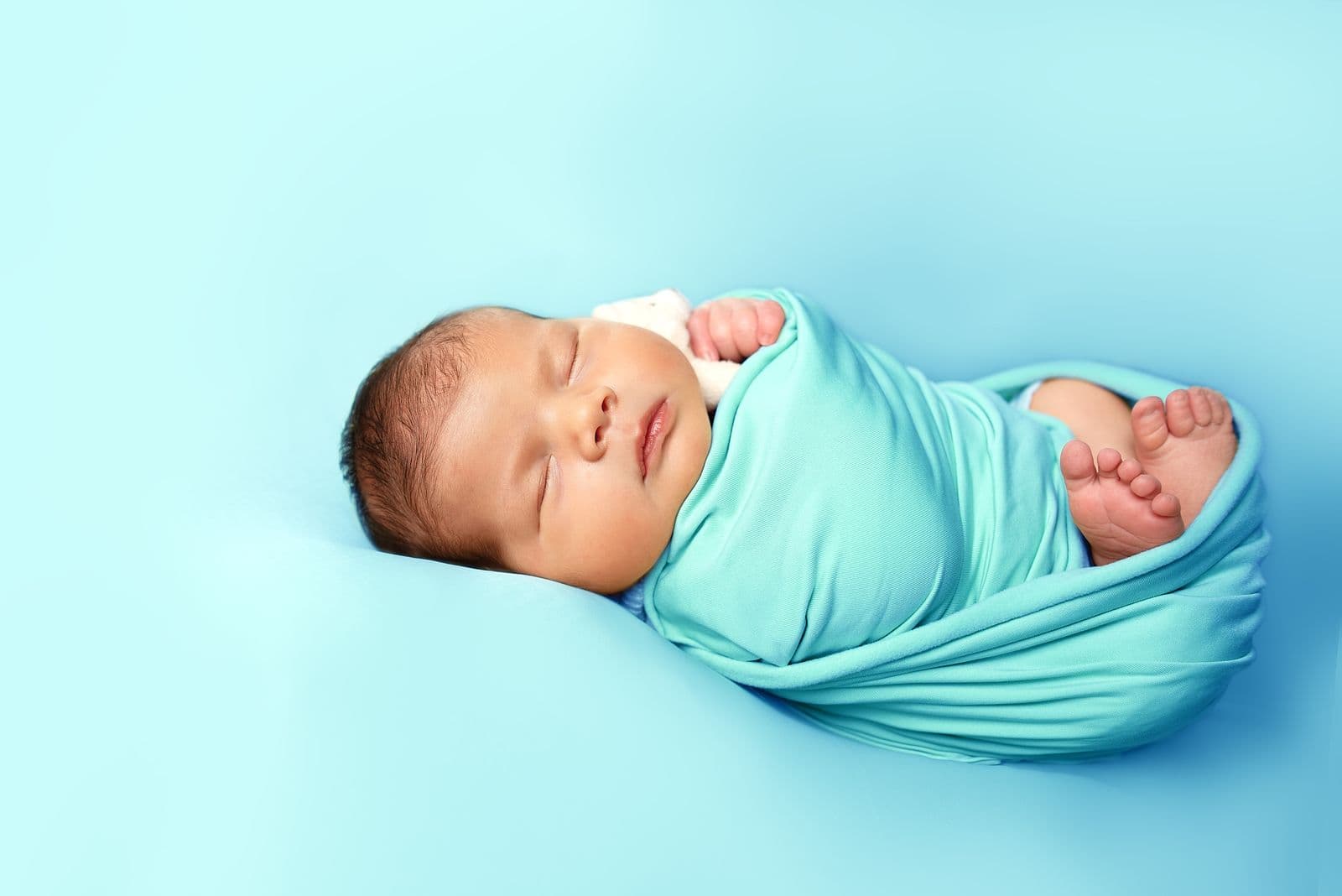 A swaddled newborn sleeping