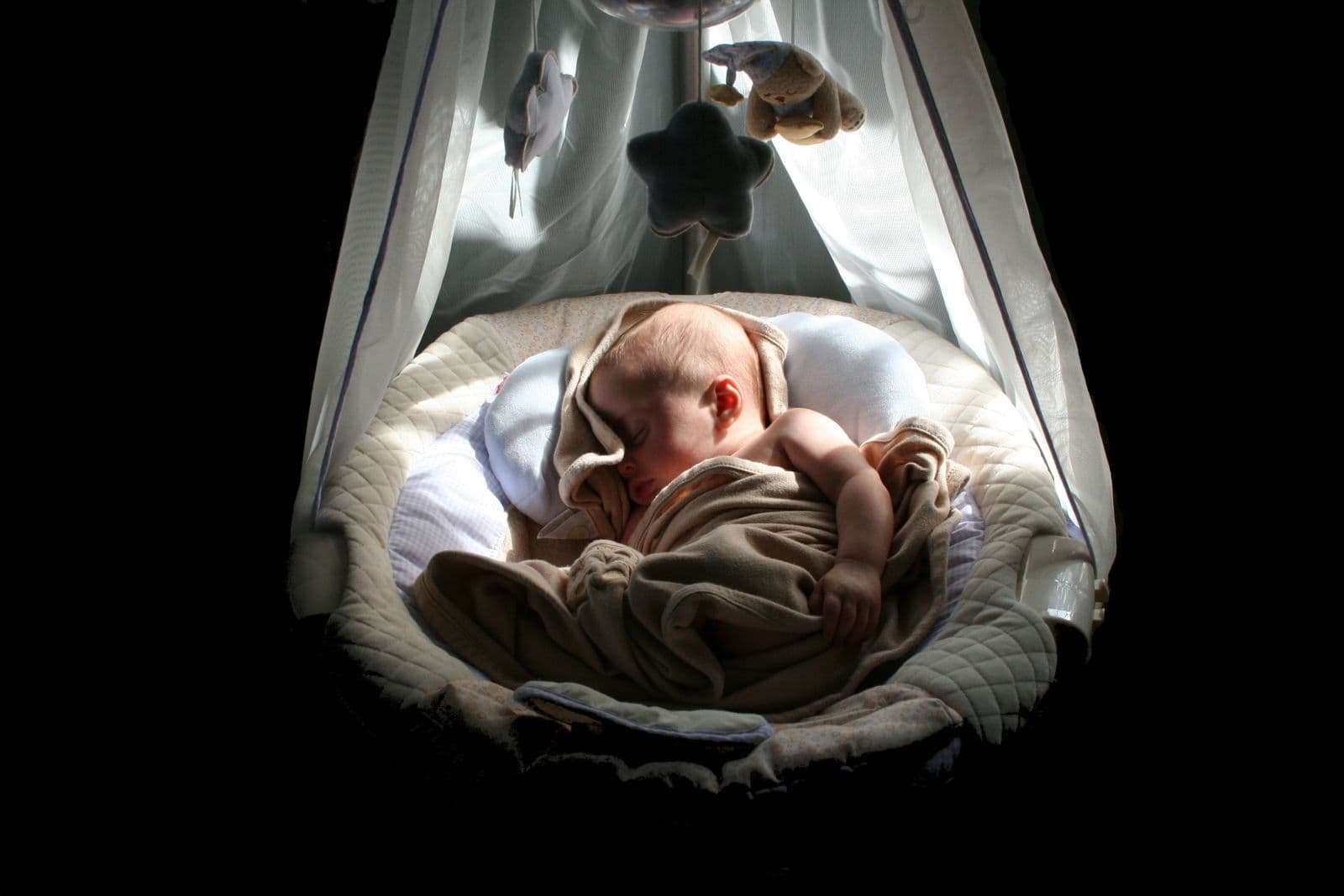 A baby napping peacefully in a cradle