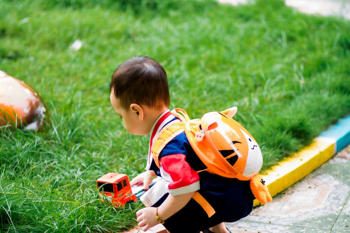 A preschooler playing outdoors in a park