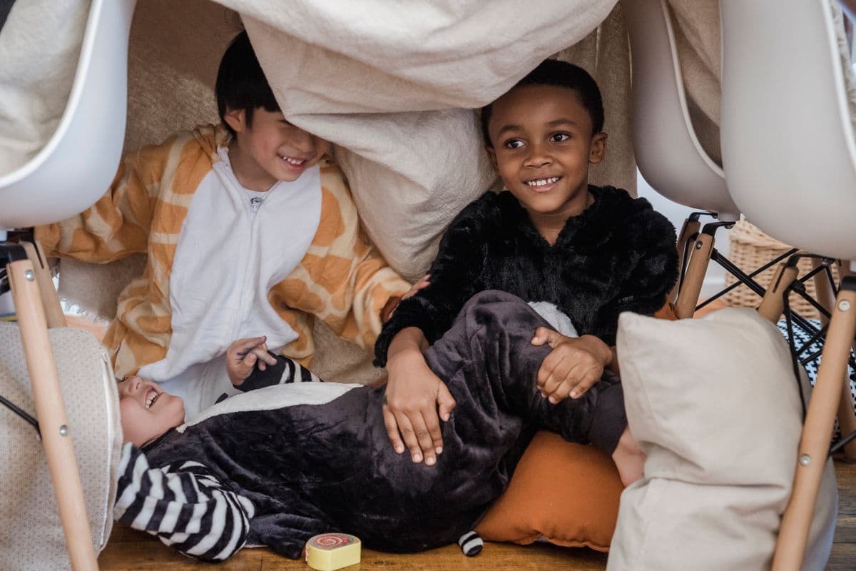 Children playing in an indoor pillow fort