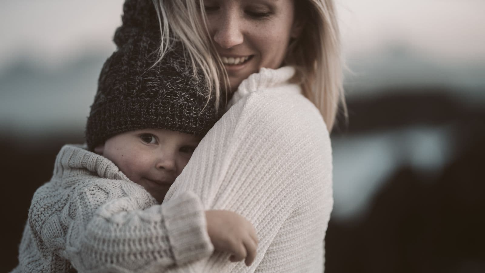 A parent tenderly holding a young child