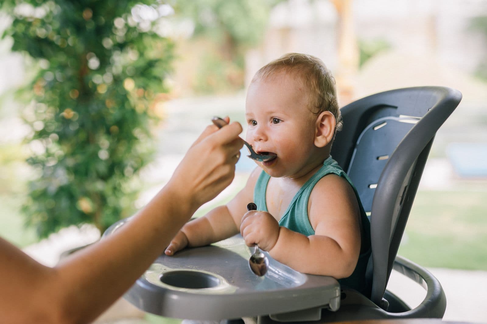 A baby being fed with a spoon